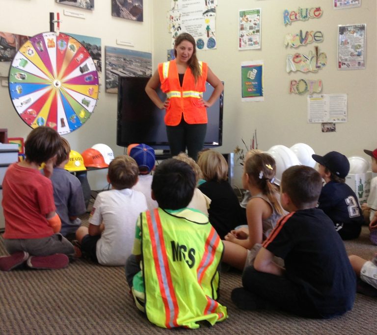 A recycling coordinator teaches students about recycling